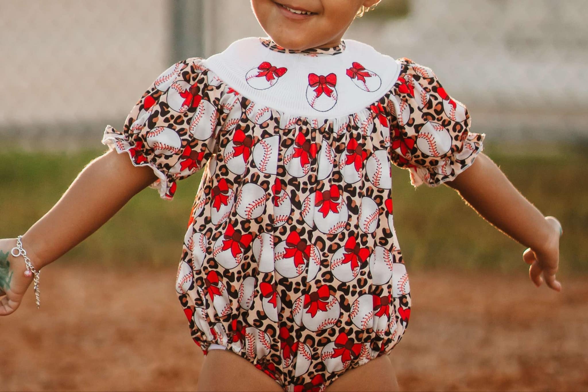 Smocked leopard baseball romper